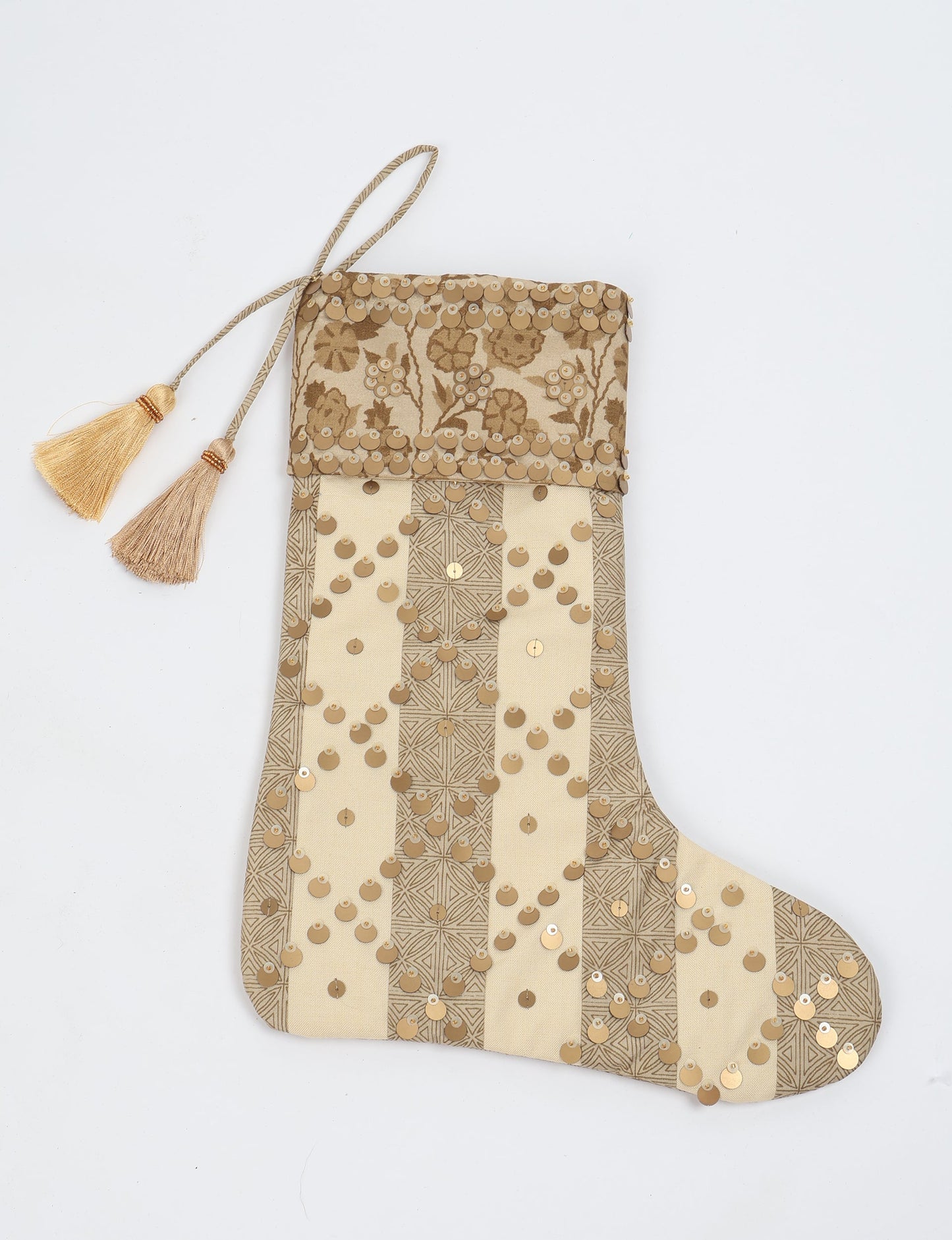 Upcycled sari Christmas stocking in ivory and cream tones with striped cotton detailing and gold embroidery; handmade eco clothing piece representing conscious clothing, recycled fashion, sustainable apparel, and fair trade fashion craftsmanship.
