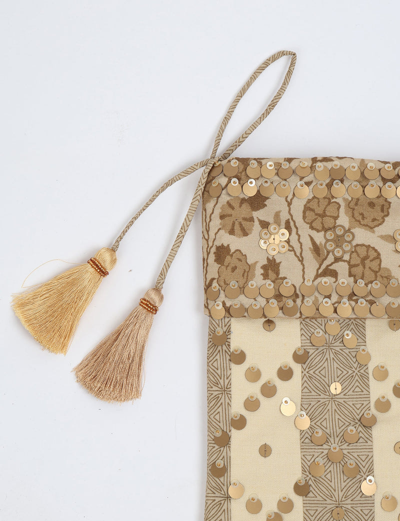 Beige and brown striped Christmas stocking with floral pattern, gold sequins, and two beige tassels on hanging loop