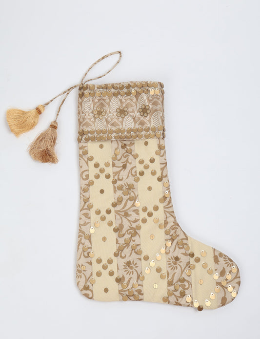 Upcycled sari Christmas stocking in ivory and cream tones with striped cotton detailing and gold embroidery; handmade eco clothing piece representing conscious clothing, recycled fashion, sustainable apparel, and fair trade fashion craftsmanship.