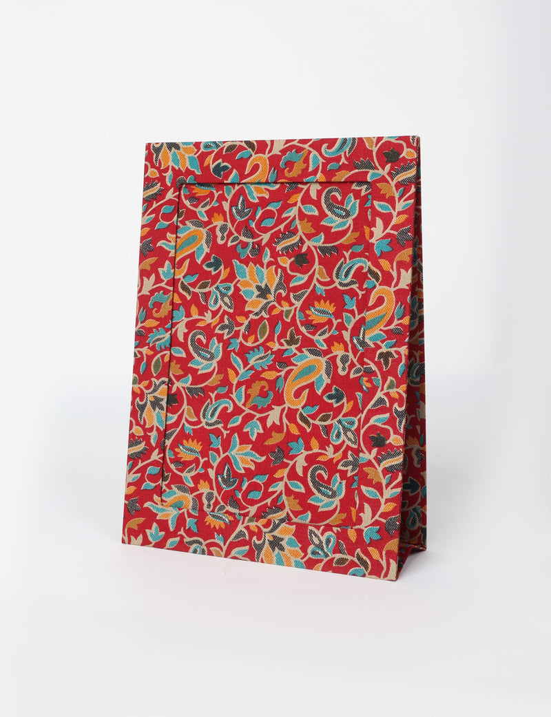 Brown tropical patterned photo frame with red background and multicolor floral design, shown standing at an angle