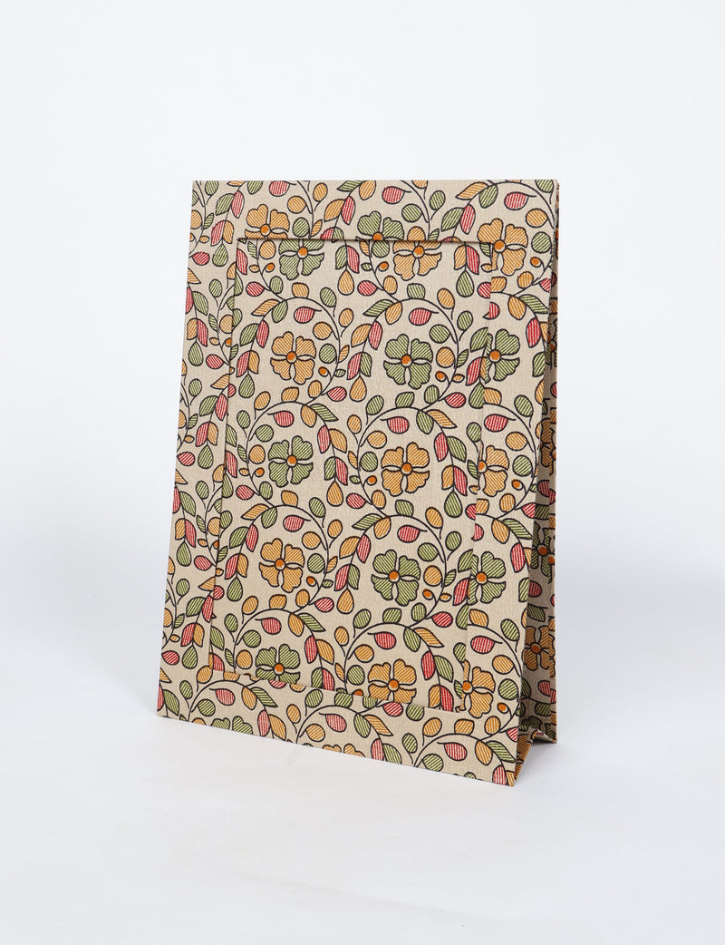 Brown tropical patterned photo frame with orange, green, and red floral design, standing upright on a white background