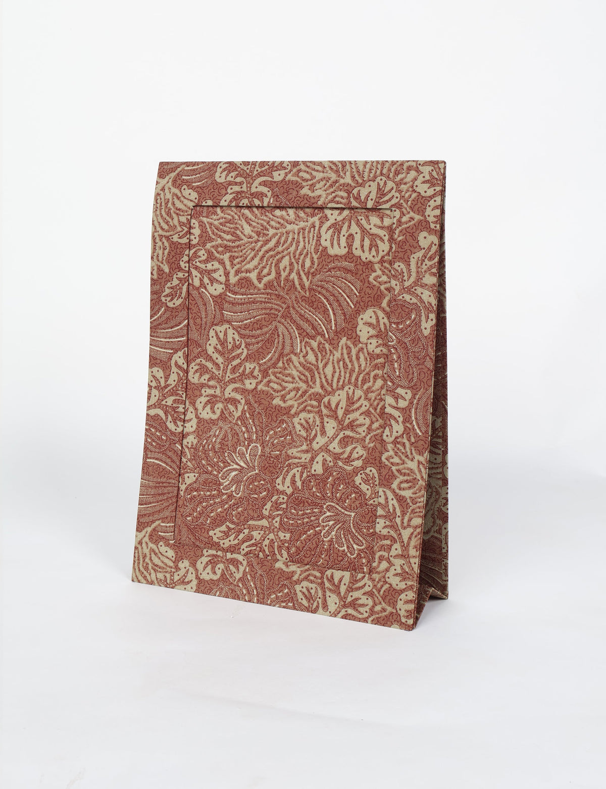 Brown tropical patterned photo frame standing upright with a textured leaf design, shown on a white background
