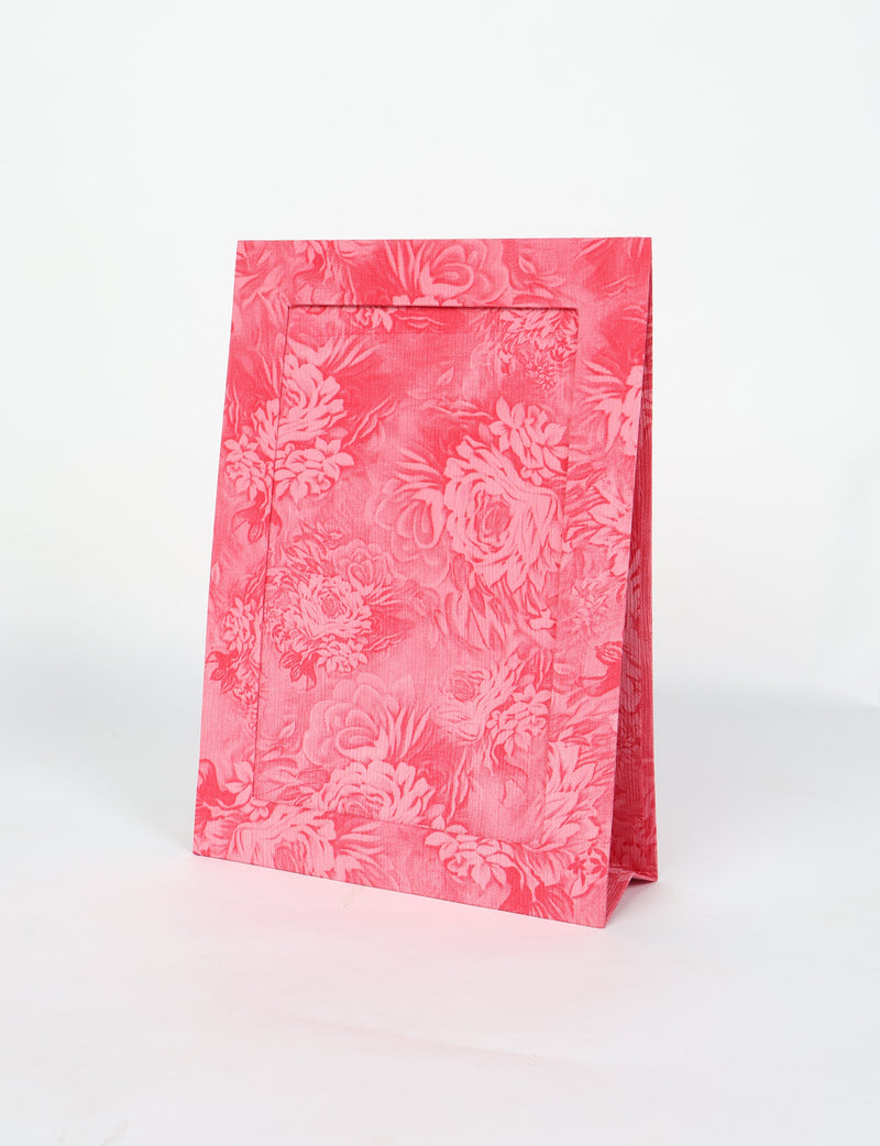 Red photo frame with tropical floral pattern, standing upright on a white background, front angled view