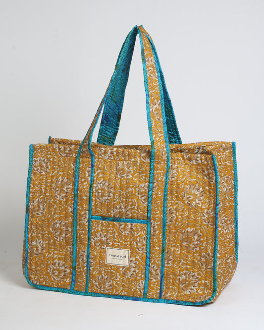 Quilted work tote bag with structured rectangular design and long shoulder straps, representing slow fashion and ethical clothing ideals, made as part of upcycled women's clothing and sustainable women's clothing using recycled fashion and earth friendly clothing practices.