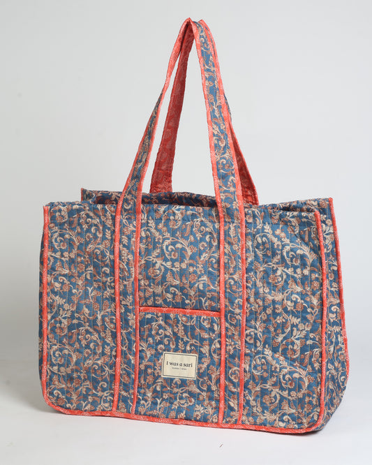Quilted work tote bag with structured rectangular design and long shoulder straps, representing slow fashion and ethical clothing ideals, made as part of upcycled women's clothing and sustainable women's clothing using recycled fashion and earth friendly clothing practices.