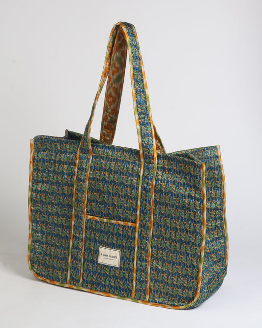 Quilted work tote bag with structured rectangular design and long shoulder straps, representing slow fashion and ethical clothing ideals, made as part of upcycled women's clothing and sustainable women's clothing using recycled fashion and earth friendly clothing practices.