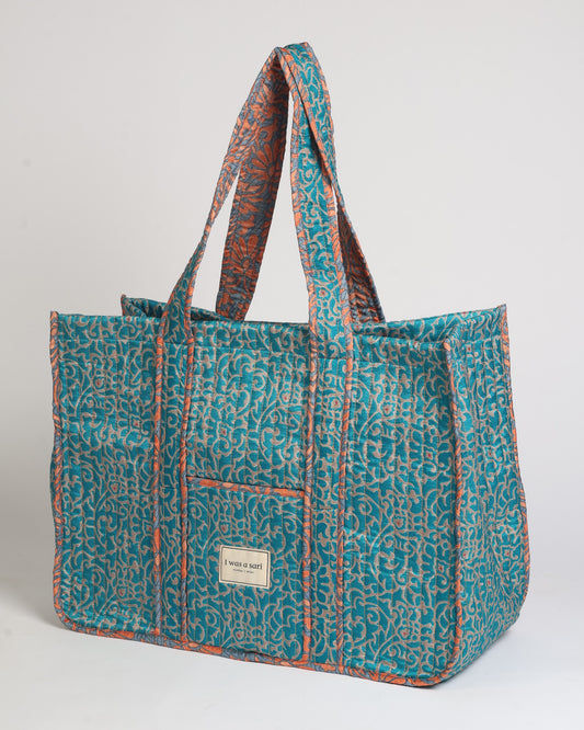 Quilted work tote bag with structured rectangular design and long shoulder straps, representing slow fashion and ethical clothing ideals, made as part of upcycled women's clothing and sustainable women's clothing using recycled fashion and earth friendly clothing practices.