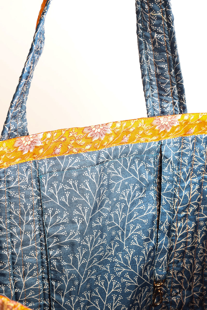 Quilted work tote bag with structured rectangular design and long shoulder straps, representing slow fashion and ethical clothing ideals, made as part of upcycled women's clothing and sustainable women's clothing using recycled fashion and earth friendly clothing practices.