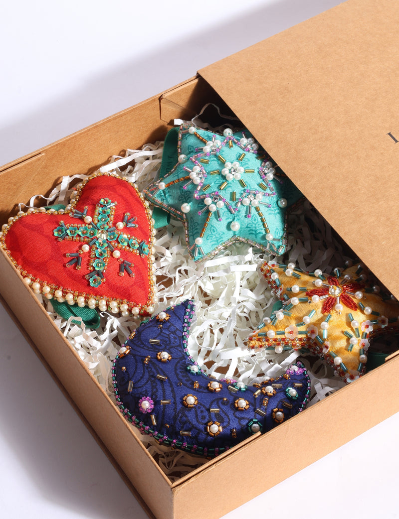 Cheer gift box set of four colourful upcycled sari ornaments in heart, star, crescent moon and snowflake shapes with hand-embroidered Aari work.