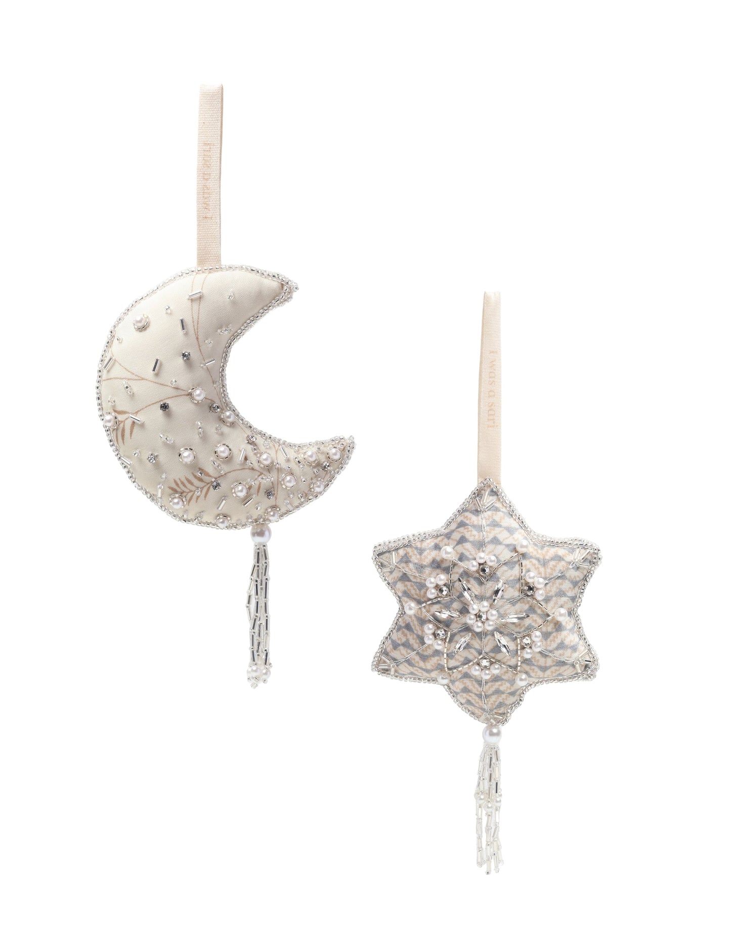 Set of two handcrafted silver ornaments — crescent moon and snowflake — made from recycled sari fabric and filled with organic cotton. Detailed with pearls, sequins, and glass beads. A festive example of upcycled clothing, eco clothing, natural clothing, recycled material clothing, products made from textile waste, repurposed clothing, carbon neutral fashion, and environment friendly clothing.