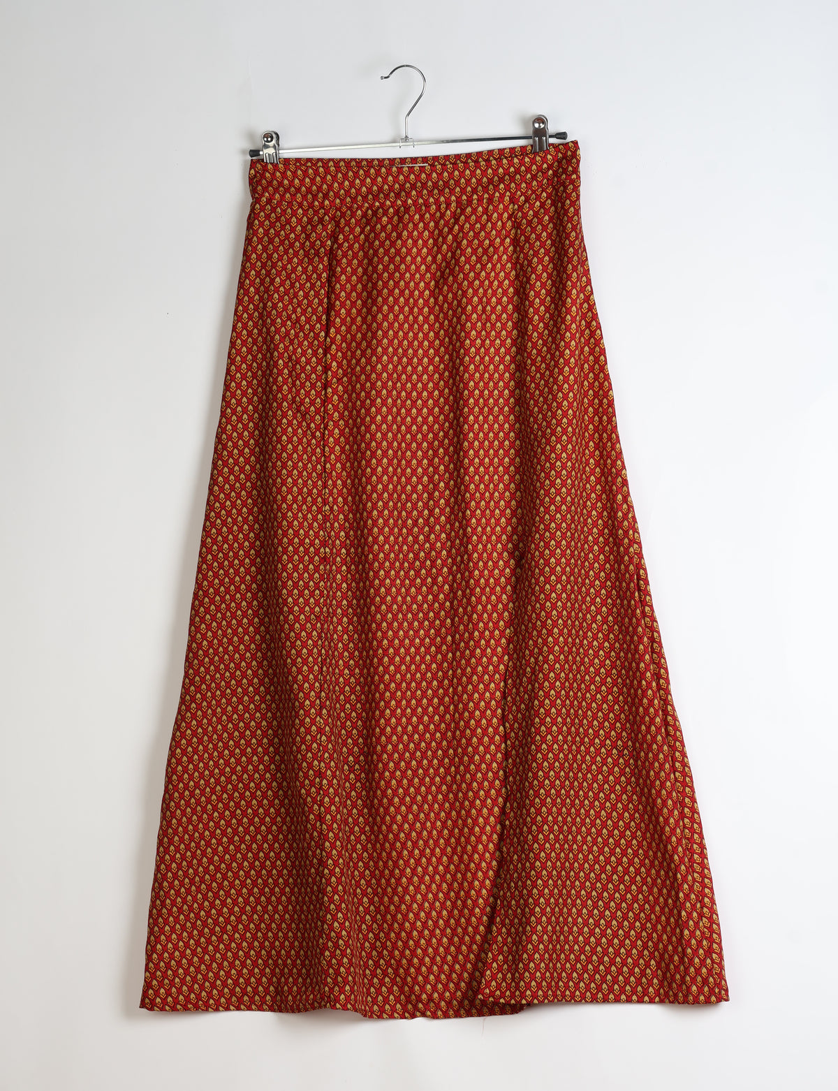 Midi A-line skirt with front slit, fitted waistband, concealed side closure, and below mid-calf length silhouette.