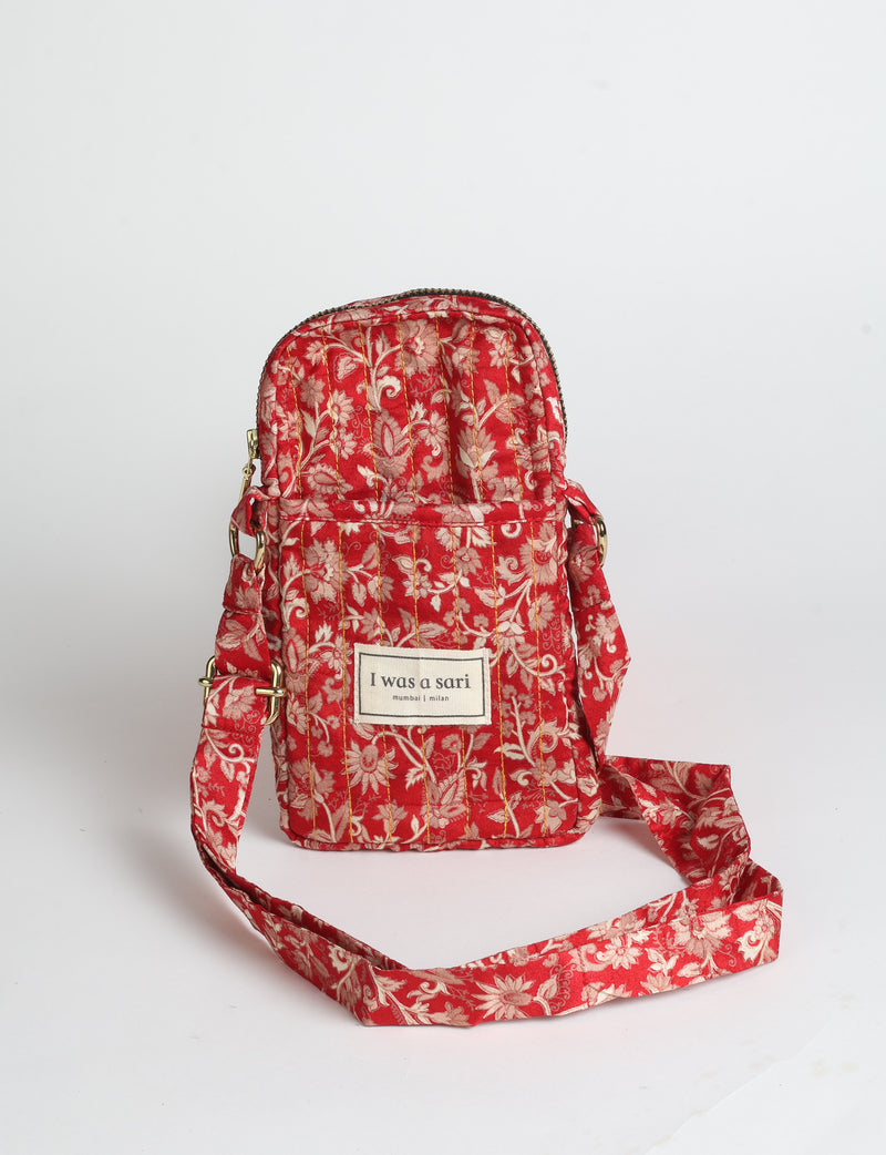 Compact quilted mobile bag featuring a padded rectangular silhouette, secure zip-top closure and adjustable crossbody strap for everyday use.