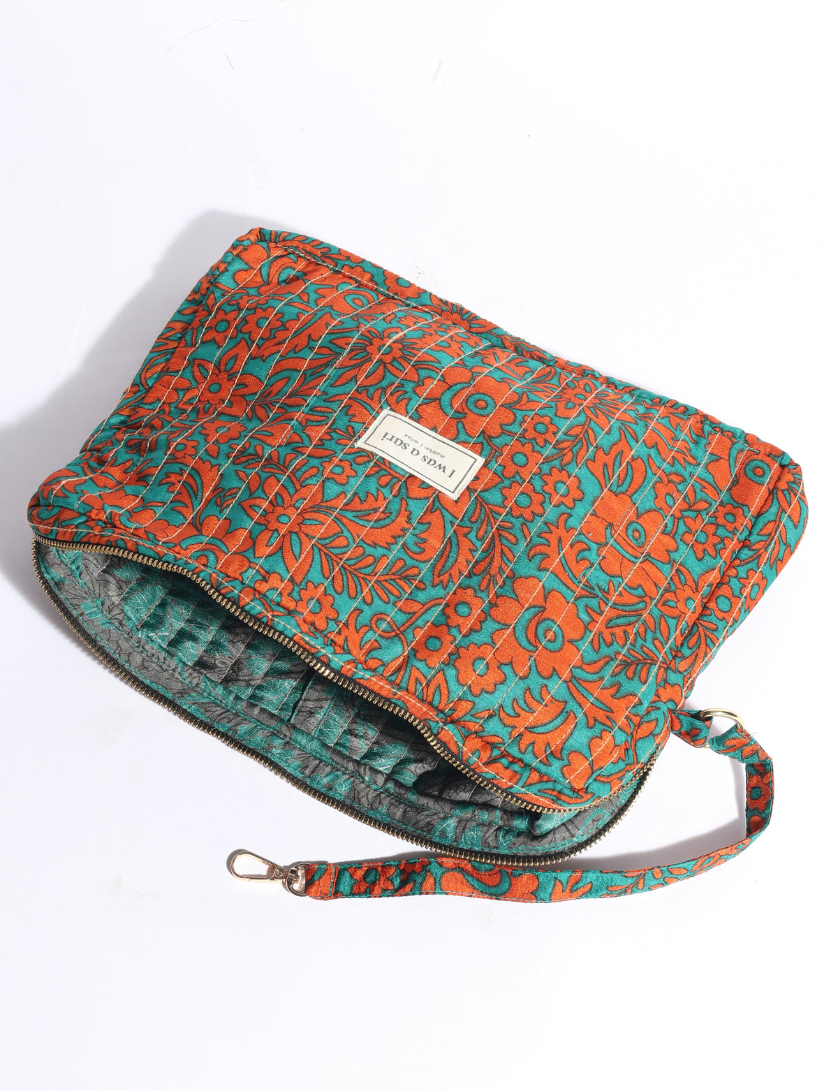 Quilted fabric organizer with orange floral pattern on teal background, zipper closure, and detachable wrist strap, flat lay