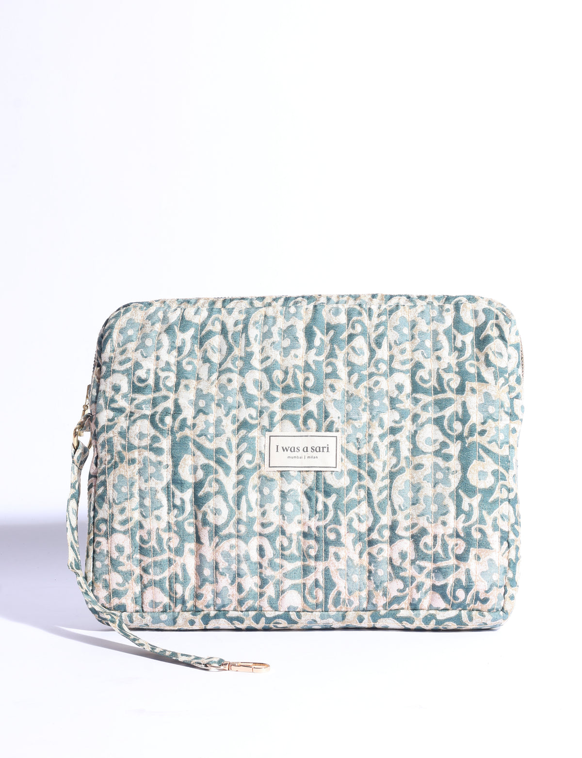 Quilted sling bag with adjustable strap, front zip pocket, and curved silhouette for everyday use
