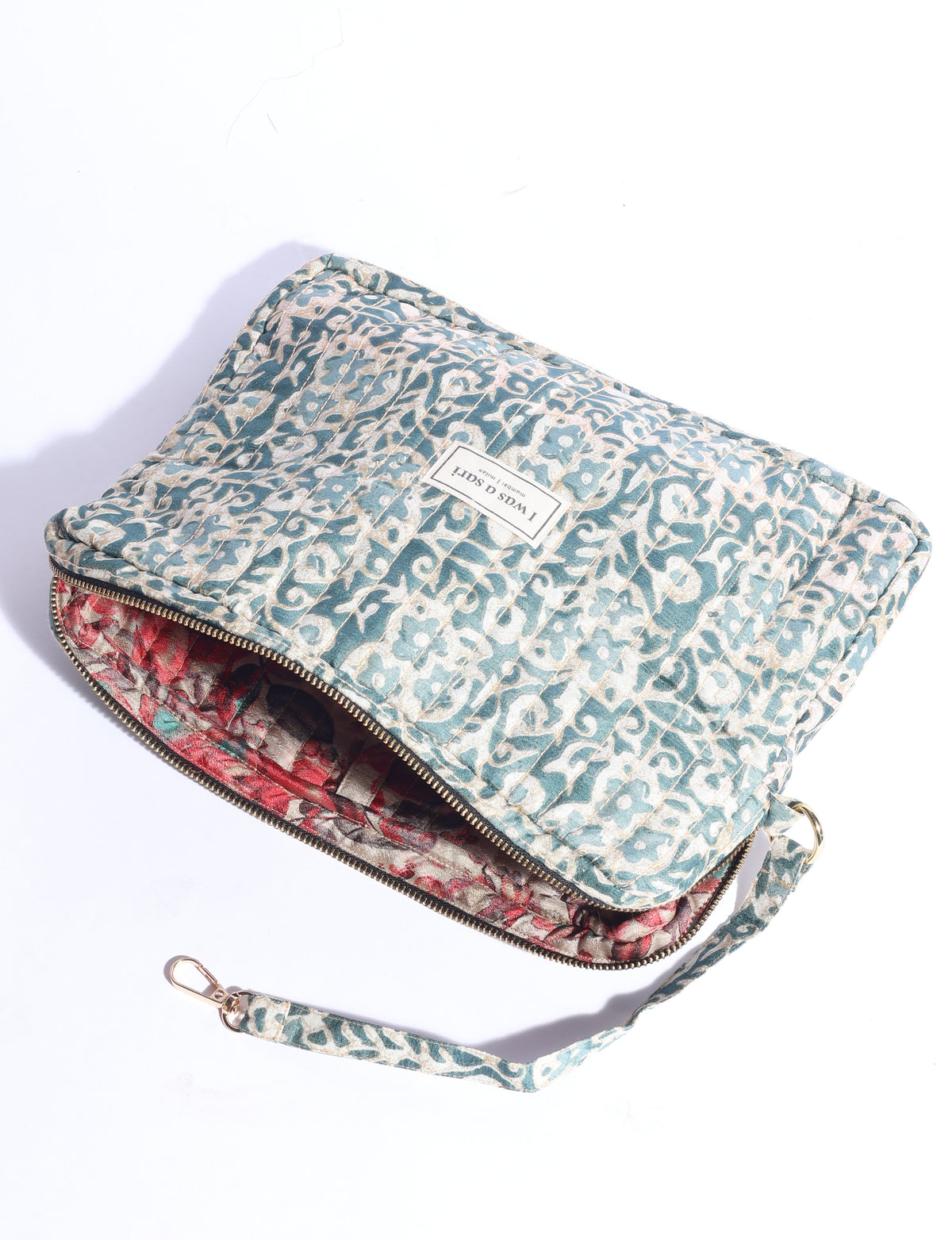 Quilted sling bag with adjustable strap, front zip pocket, and curved silhouette for everyday use