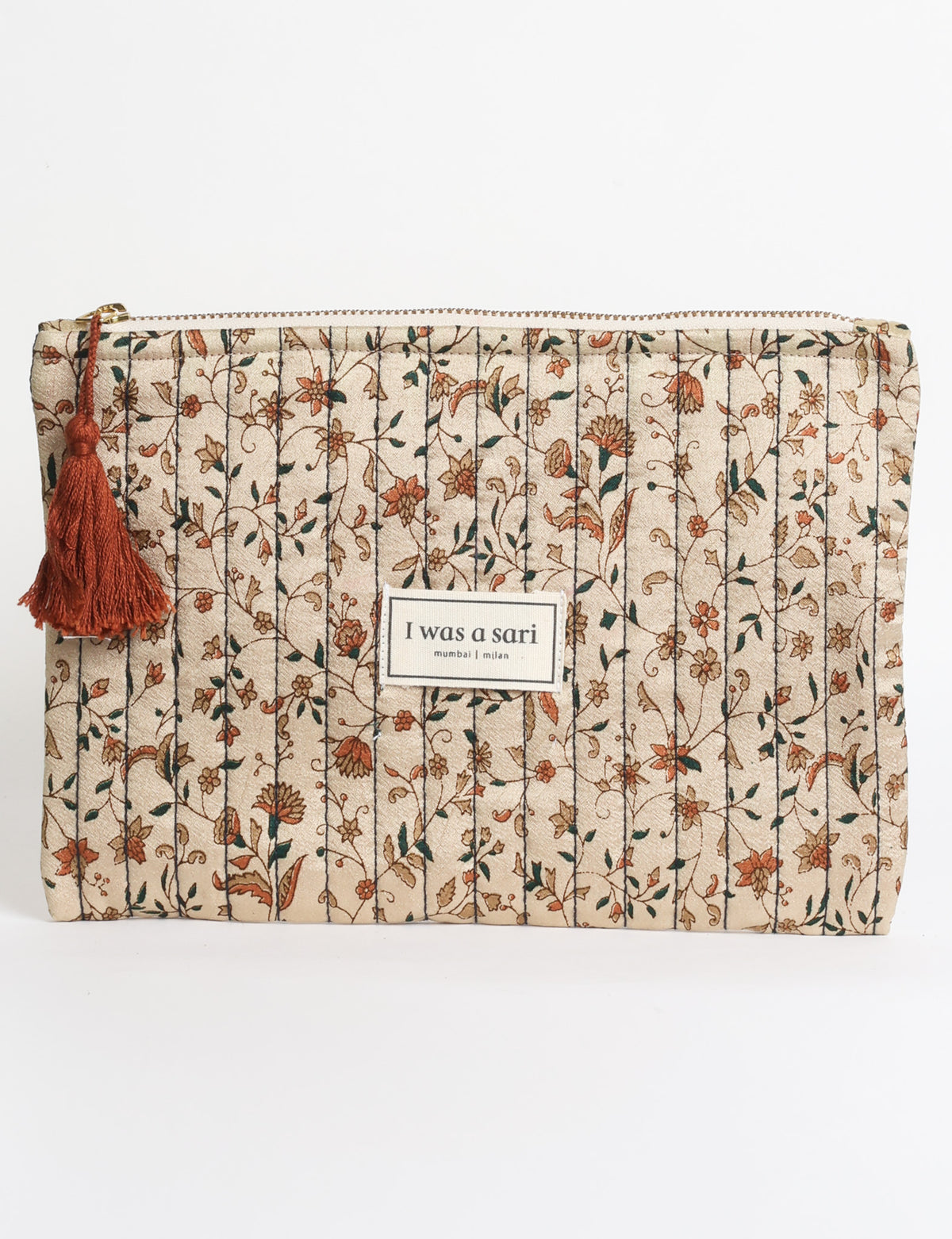 Quilted zipper pouch with tassel trim, available in three sizes for organising everyday essentials.