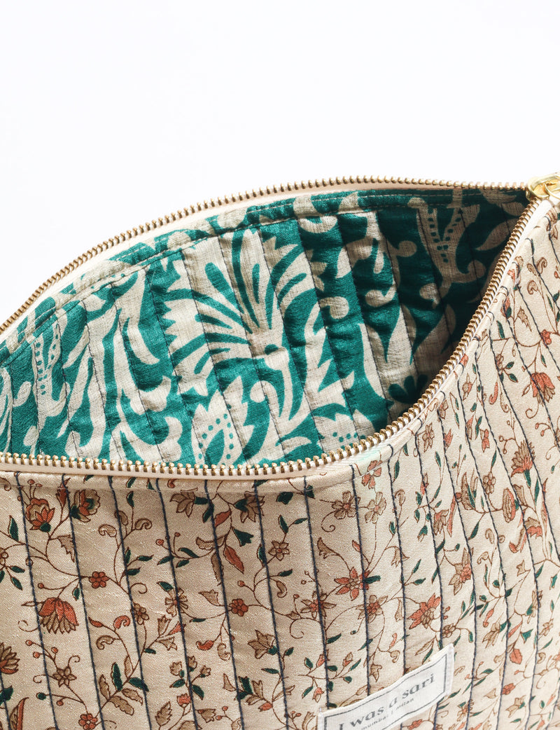 Quilted zipper pouch with tassel trim, available in three sizes for organising everyday essentials.