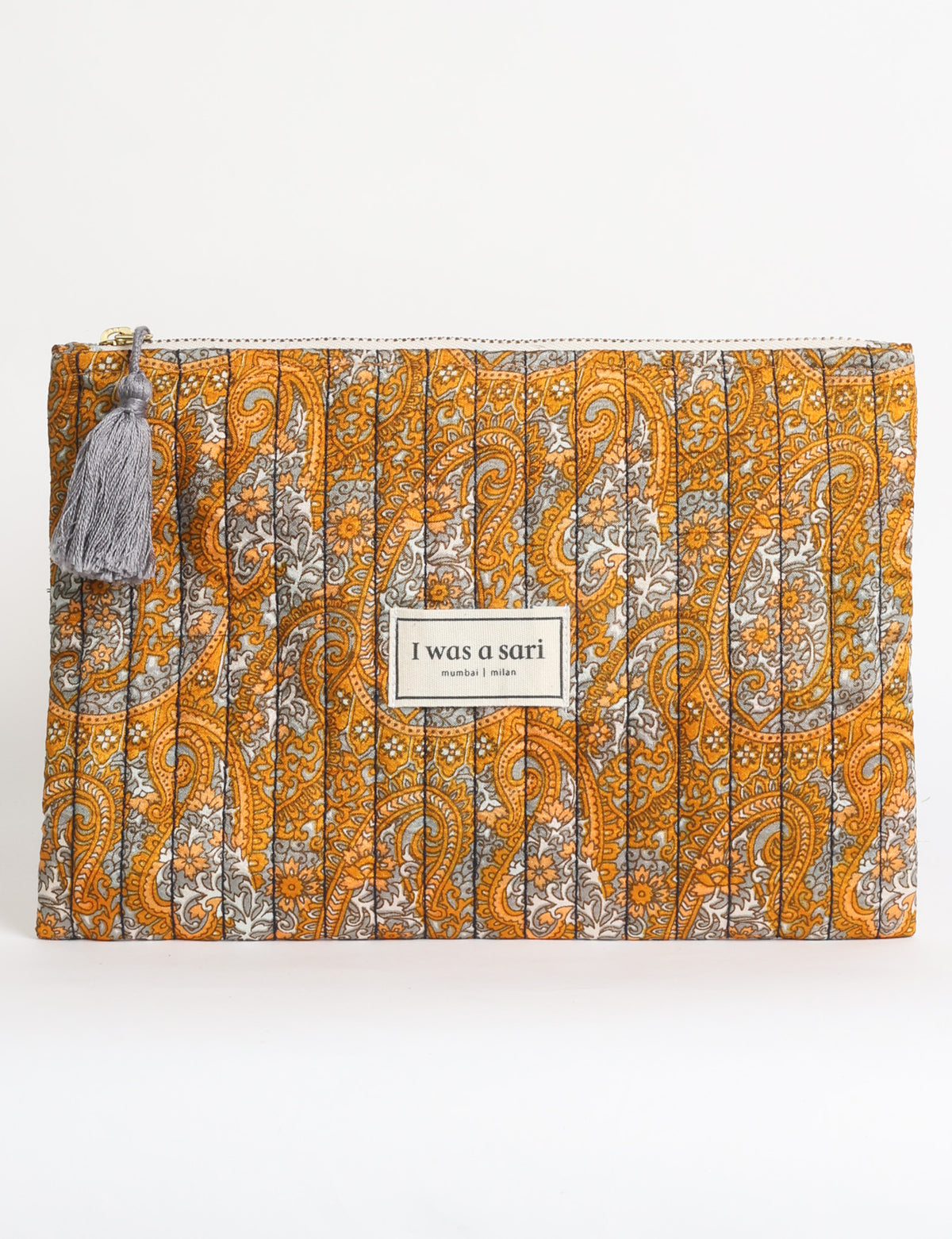 Quilted zipper pouch with tassel trim, available in three sizes for organising everyday essentials.