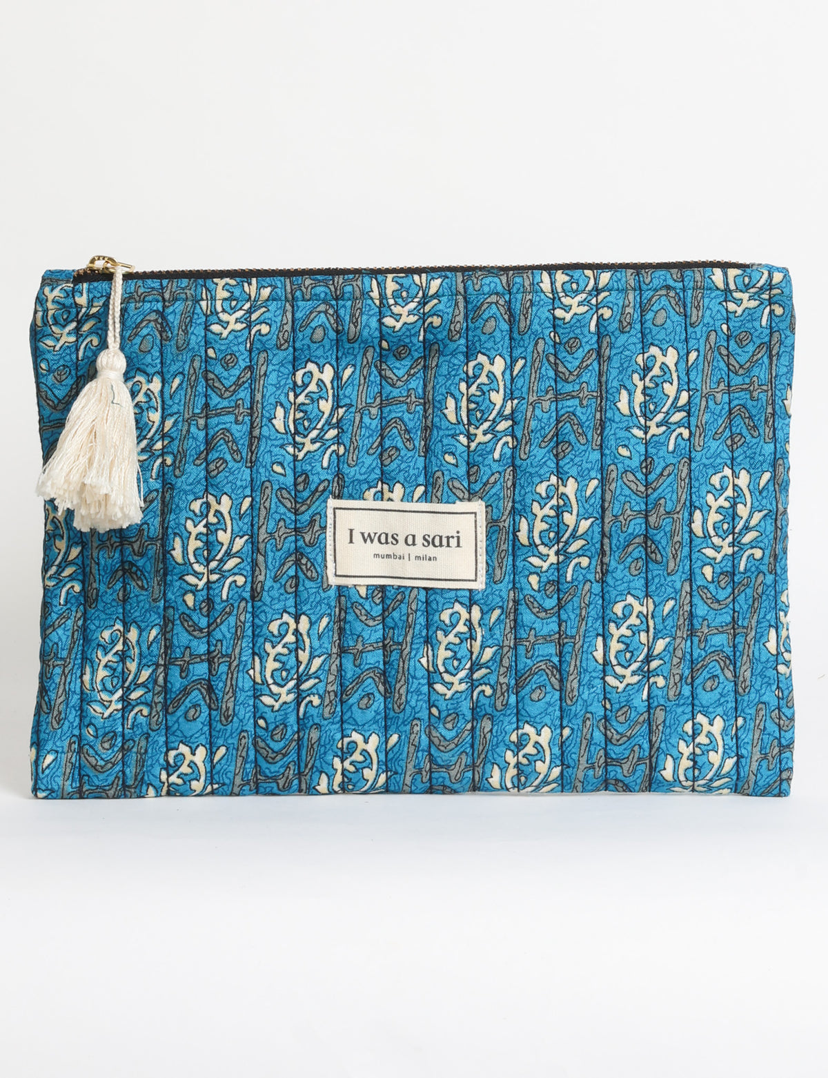 Quilted zipper pouch with tassel trim, available in three sizes for organising everyday essentials.