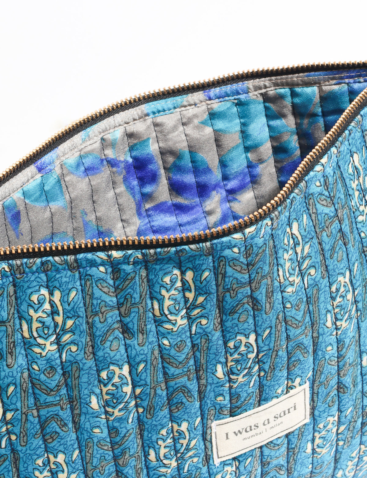 Quilted zipper pouch with tassel trim, available in three sizes for organising everyday essentials.