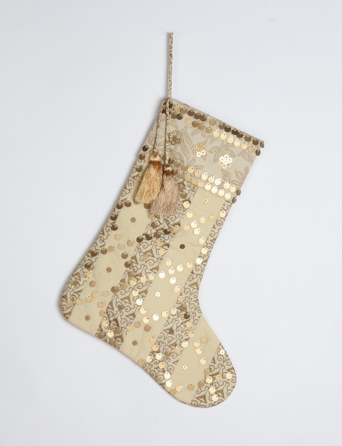 Christmas stocking with beige and brown vertical stripes, floral pattern, gold sequins, and two tassels on hanging loop