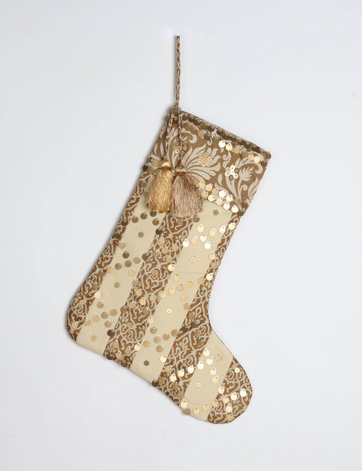 Christmas stocking with beige and brown vertical stripes, floral pattern, gold sequins, and two tassels on hanging loop