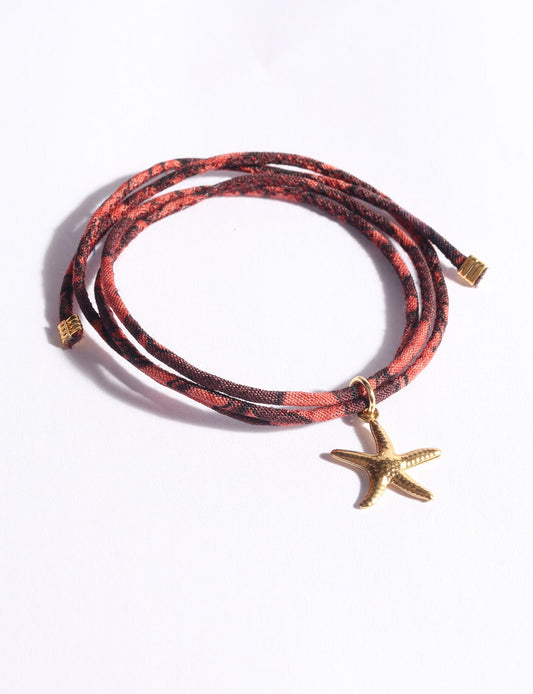 Slim adjustable cord bracelet with gold-plated stainless steel star fish charm inspired by upcycled women’s clothing, sustainable women’s clothing, eco friendly clothes, recycled sustainable fashion, carbon neutral clothing, and environment friendly clothing values.