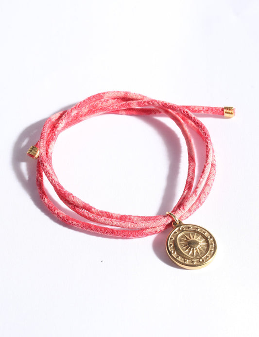 Slim adjustable cord bracelet with gold-plated stainless steel sun charm, inspired by upcycled women’s clothing, sustainable women’s clothing, eco friendly fashion, recycled sustainable fashion, carbon neutral fashion, and environment friendly clothing values.