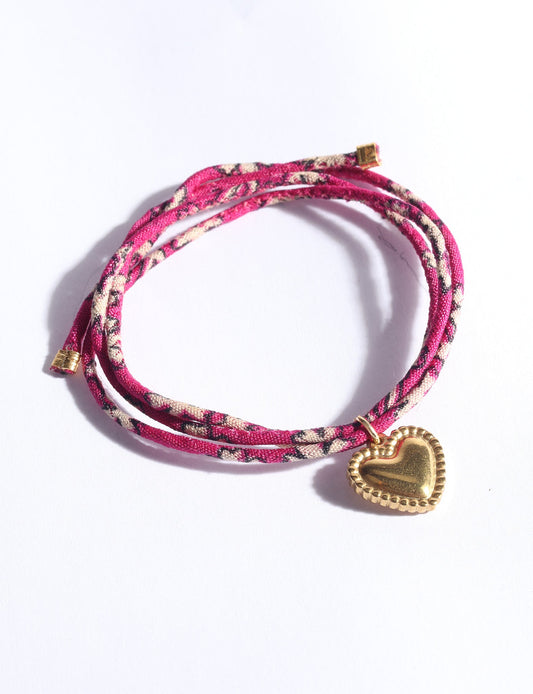 Slim adjustable cord bracelet with gold-plated stainless steel heart charm inspired by upcycled women’s clothing, sustainable women’s clothing, eco friendly fashion, recycled sustainable fashion, carbon neutral fashion, and environment friendly clothes values.