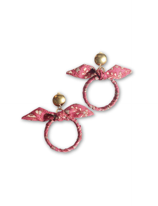 Drop earrings with bow detail and circular ring inspired by upcycled women’s clothing, sustainable women’s clothing, eco friendly clothes, recycled sustainable fashion, carbon neutral clothing, and environment friendly clothing values.