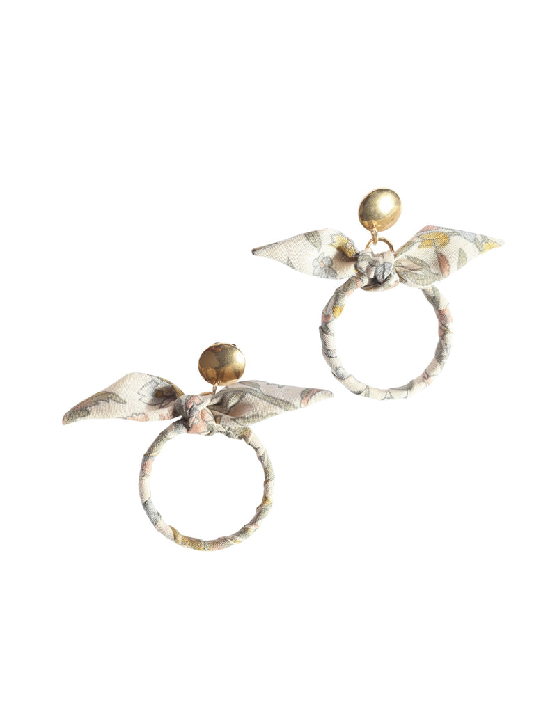 Beige tropical bow earrings with gold-tone round studs and fabric-wrapped circular hoops with floral print bows