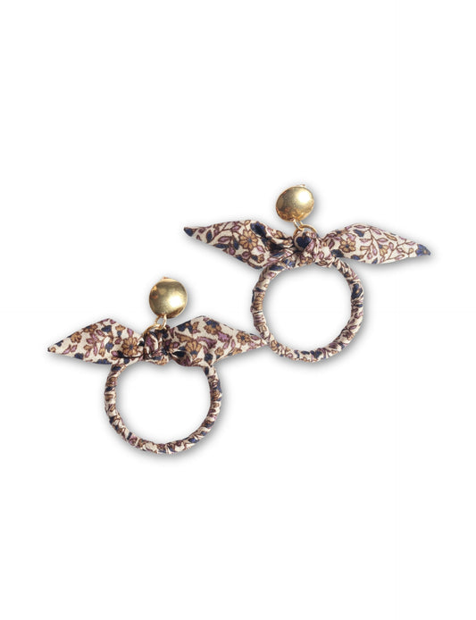 Drop earrings with bow detail and circular ring inspired by upcycled women’s clothing, sustainable women’s clothing, eco friendly clothes, recycled sustainable fashion, carbon neutral clothing, and environment friendly clothing values.