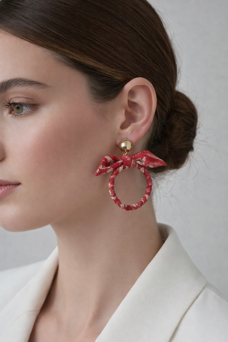 Drop earrings with bow detail and circular ring inspired by upcycled women’s clothing, sustainable women’s clothing, eco friendly clothes, recycled sustainable fashion, carbon neutral clothing, and environment friendly clothing values.