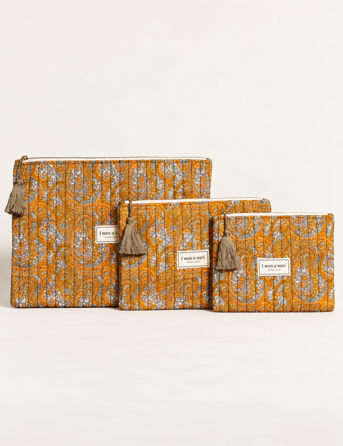 Quilted zipper pouch with tassel trim, available in three sizes for organising everyday essentials.