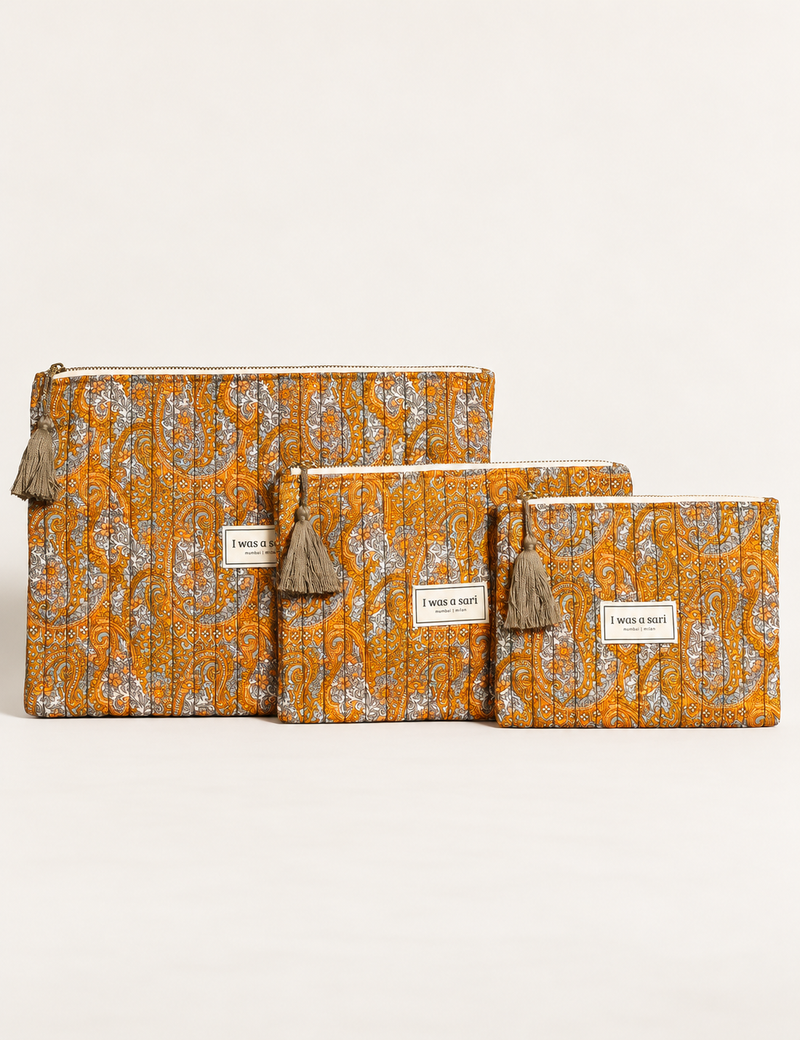 Quilted zipper pouch with tassel trim, available in three sizes for organising everyday essentials.