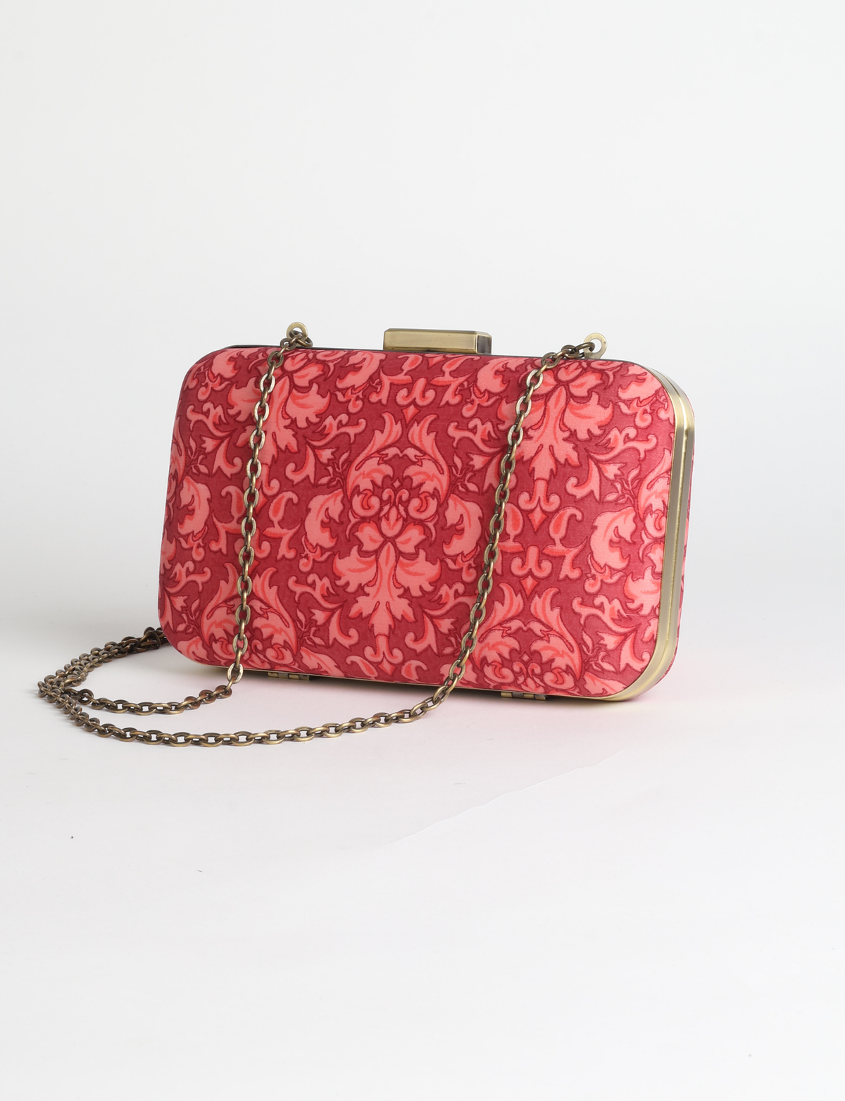 Structured box clutch bag featuring a rigid metal frame, secure clasp closure, detachable metal chain strap, and compact rectangular silhouette.