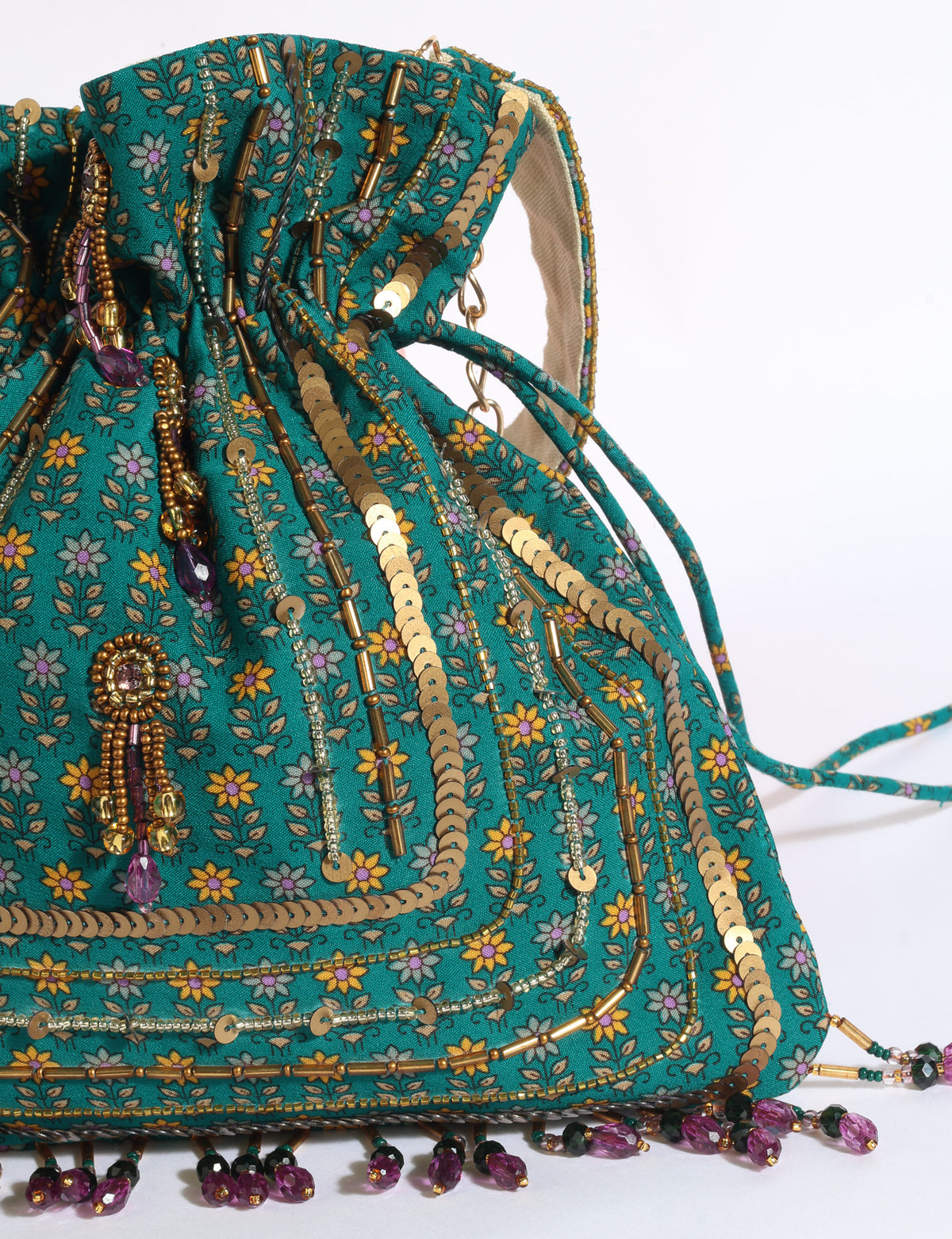 Embroidered DO GOOD potli bag made from upcycled sari fabric with tassel closure and detachable metal chain strap.