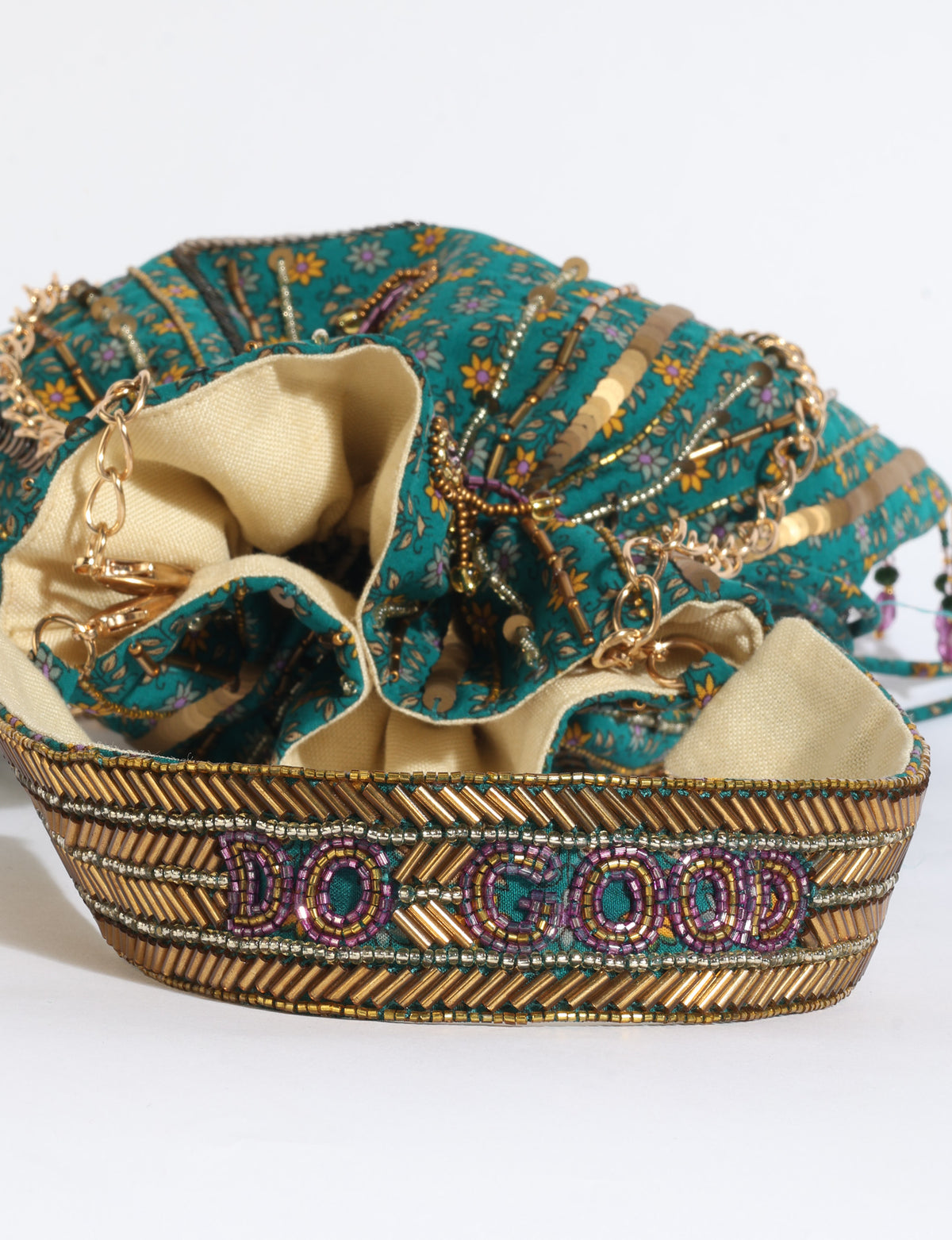 Embroidered DO GOOD potli bag made from upcycled sari fabric with tassel closure and detachable metal chain strap.