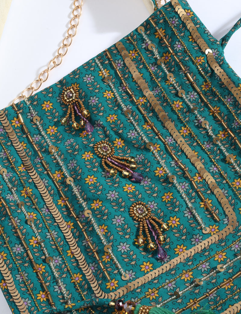 Embroidered DO GOOD potli bag made from upcycled sari fabric with tassel closure and detachable metal chain strap.