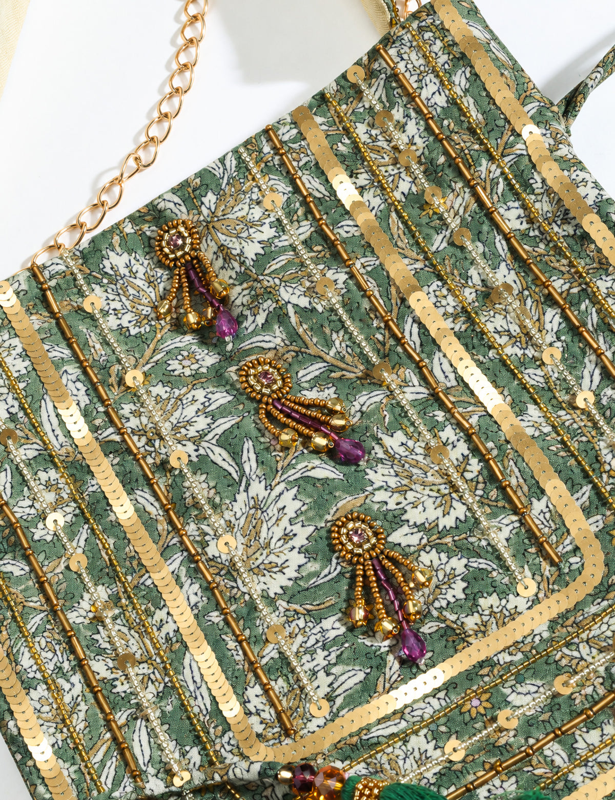 Embroidered DO GOOD potli bag made from upcycled sari fabric with tassel closure and detachable metal chain strap.