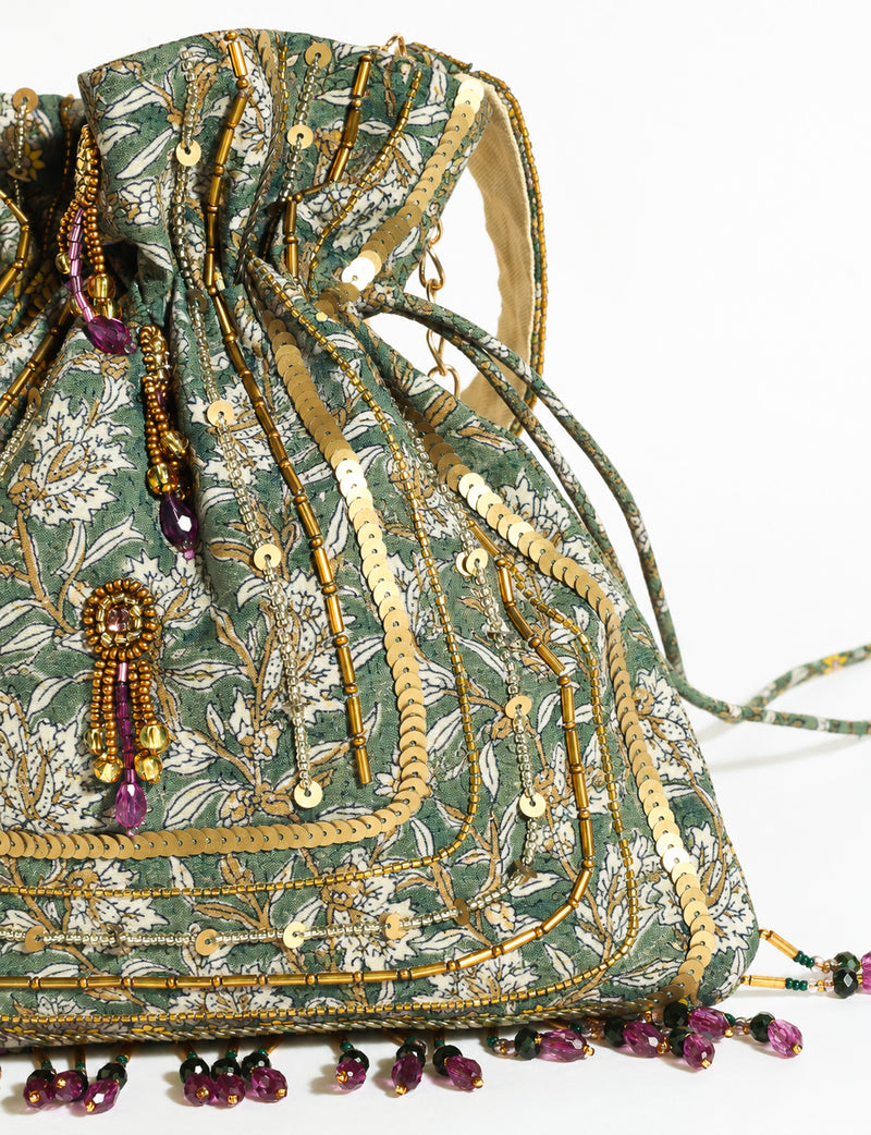 Embroidered DO GOOD potli bag made from upcycled sari fabric with tassel closure and detachable metal chain strap.