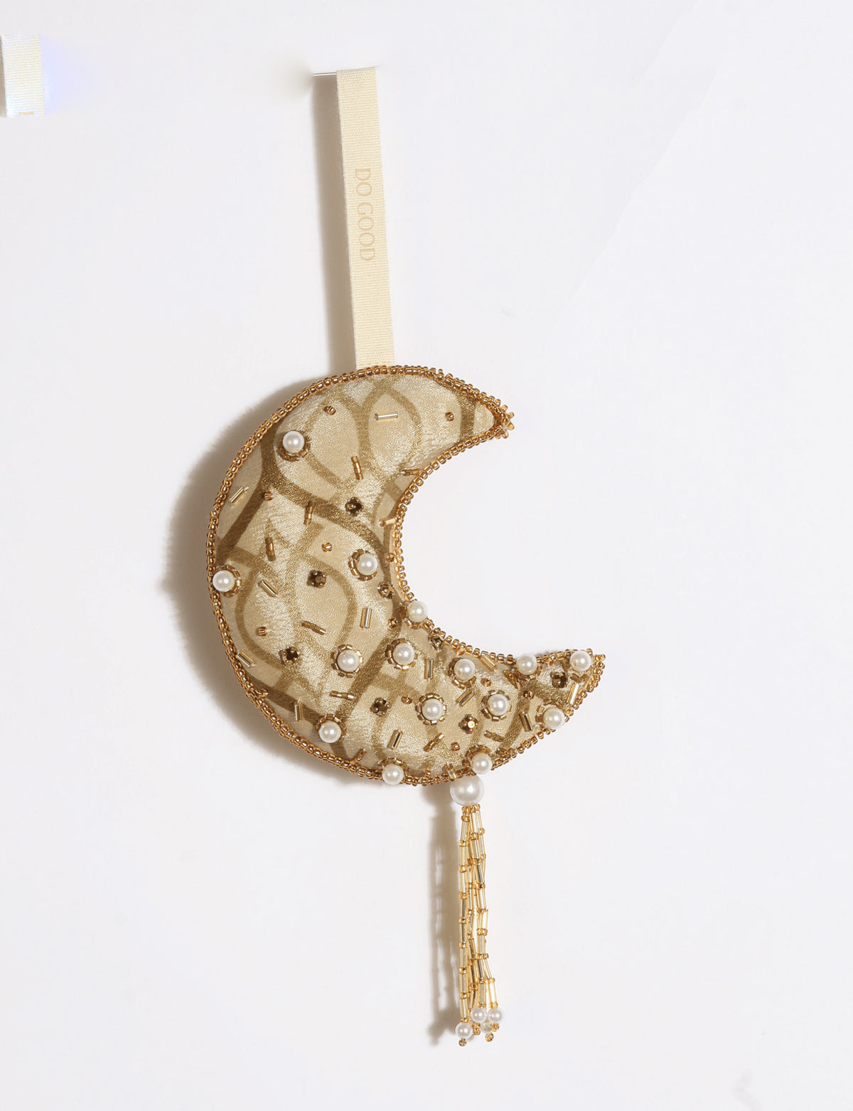 Gold and ivory crescent moon ornament made from preloved saris with silver embroidery, beads, sequins, pearls and tassel.