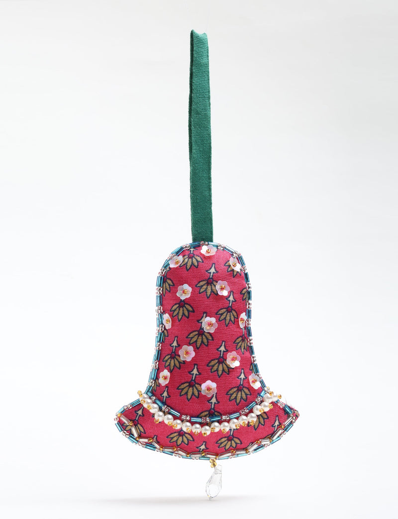 Red fabric bell ornament with floral print, beaded edges, pearl accents, and green hanging loop, front view on white background