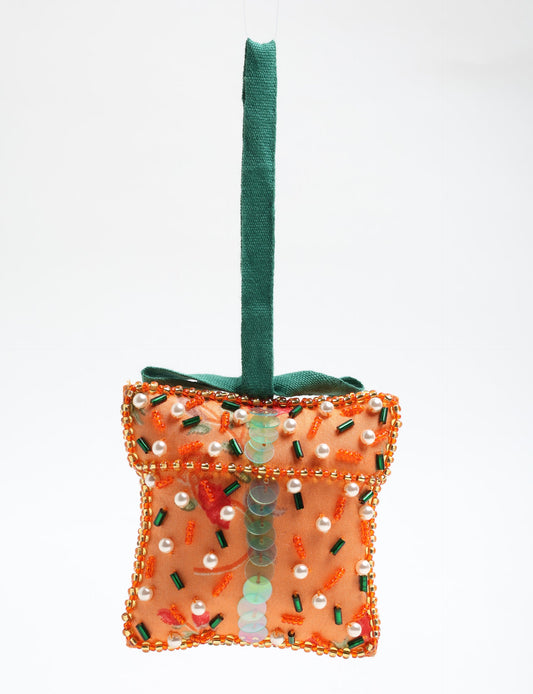 Upcycled bell-shaped Cheer Gift Ornament handmade from recycled sari fabric and decorated with pearls and sequins — an example of eco friendly fashion, recycled clothing, and circular fashion. A festive, earth-friendly decoration from Fair trade fashion and environmentally friendly clothing craftsmanship.