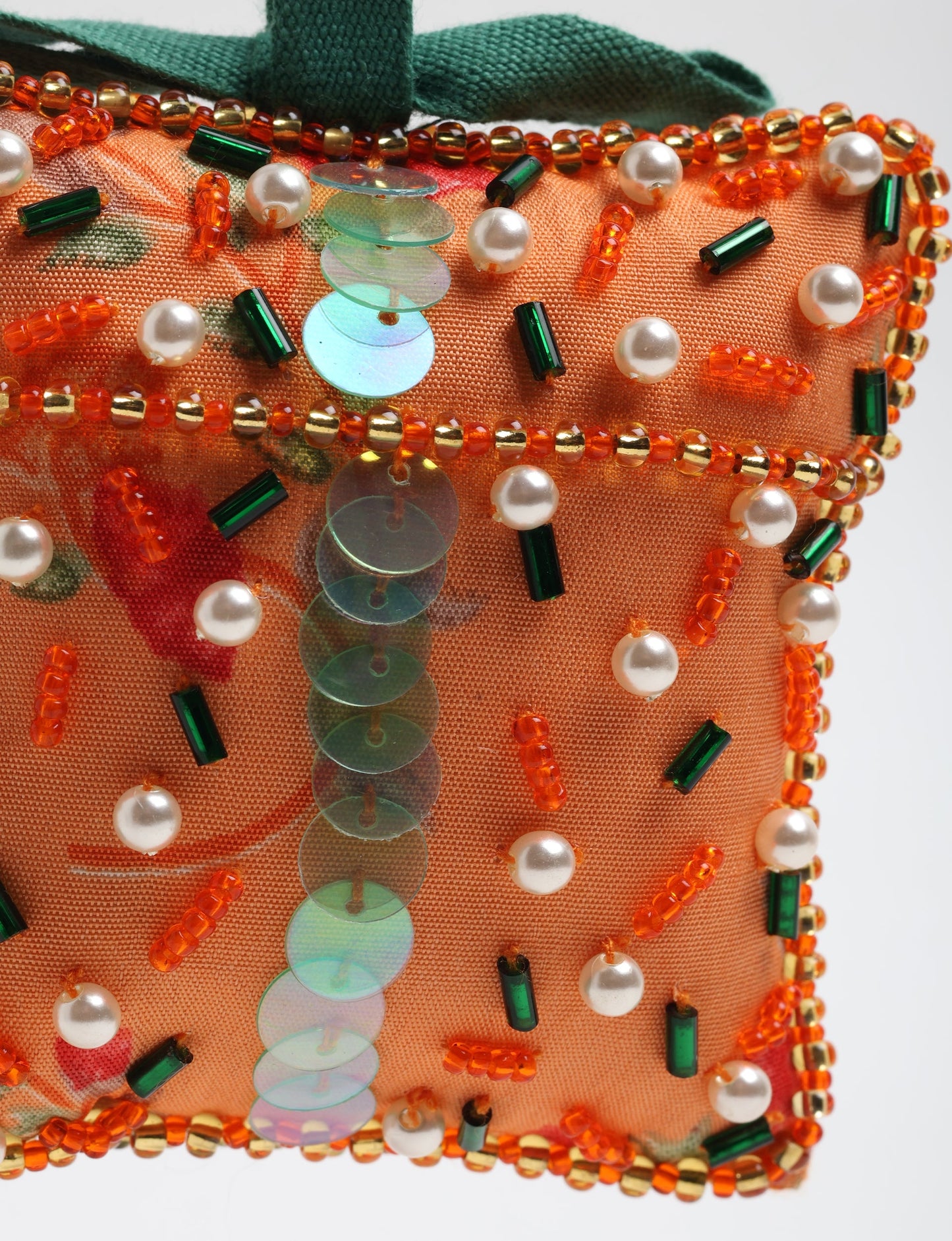 Upcycled bell-shaped Cheer Gift Ornament handmade from recycled sari fabric and decorated with pearls and sequins — an example of eco friendly fashion, recycled clothing, and circular fashion. A festive, earth-friendly decoration from Fair trade fashion and environmentally friendly clothing craftsmanship.