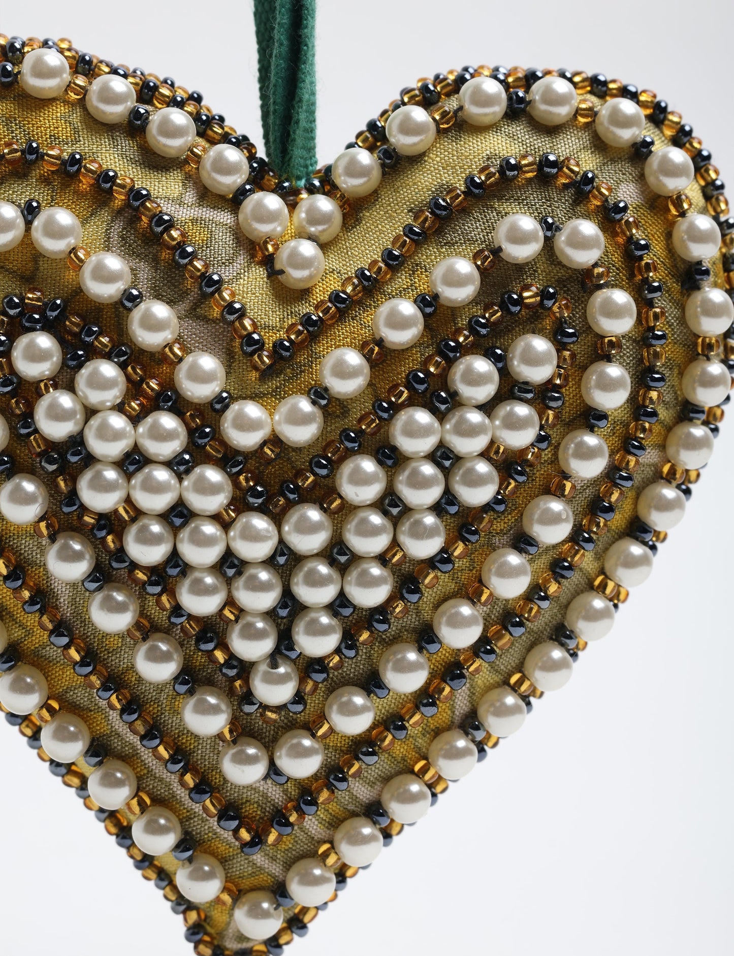 Cheer Heart Ornament made from recycled sari fabric, featuring pearl and bead embroidery. A handcrafted piece of upcycled women’s clothing art that embodies conscious clothing, natural textiles, and sustainable women’s fashion for an environmentally friendly holiday look.