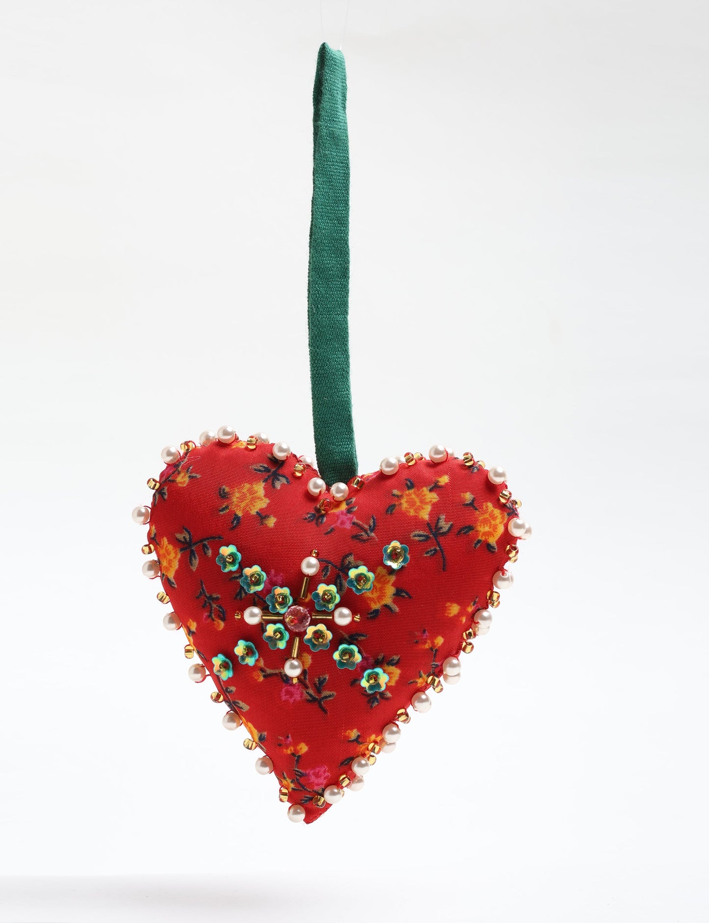 Cheer Heart Ornament made from recycled sari fabric, featuring pearl and bead embroidery. A handcrafted piece of upcycled women’s clothing art that embodies conscious clothing, natural textiles, and sustainable women’s fashion for an environmentally friendly holiday look.