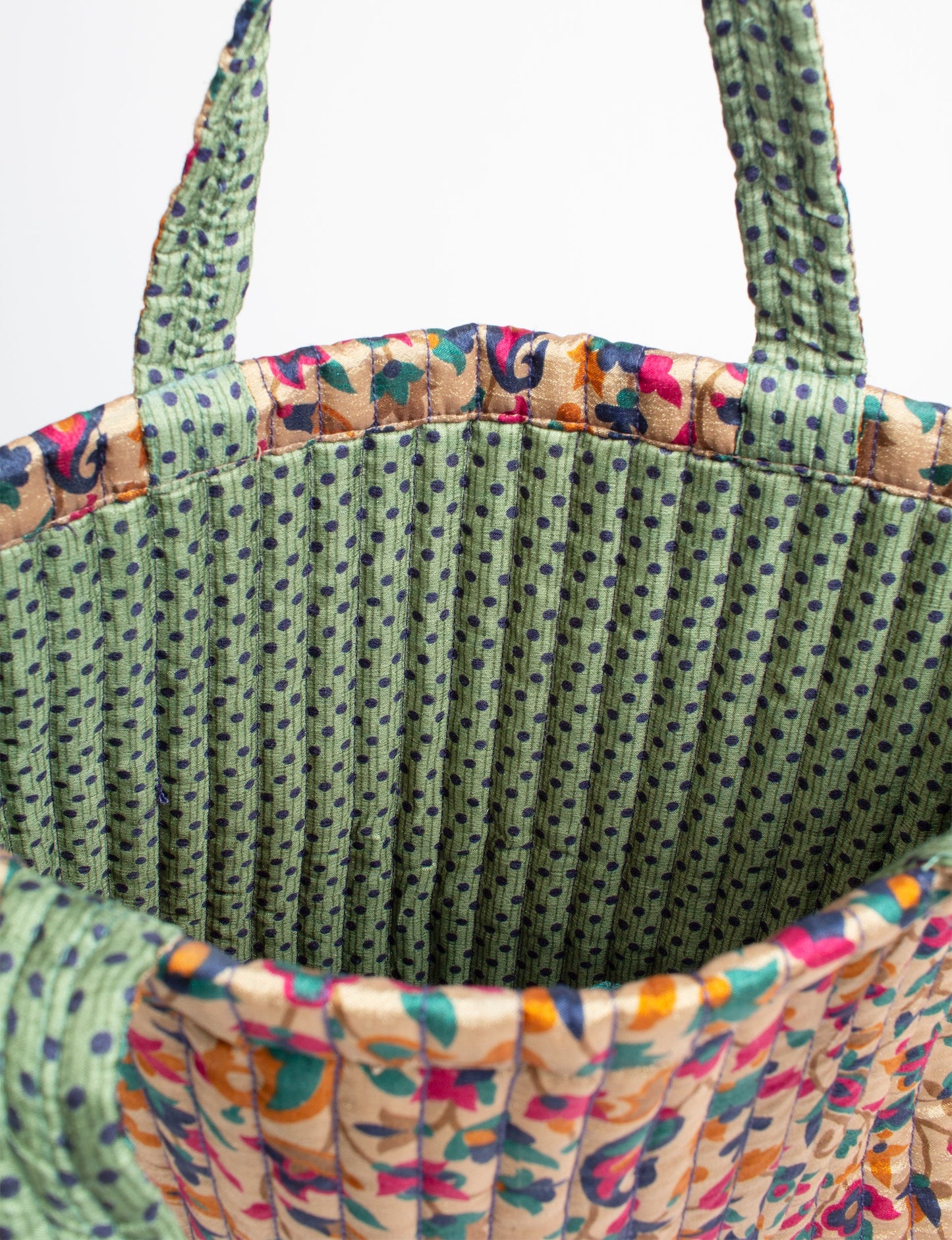 Elevate your style sustainably with our QUILTED SHOPPER BAG. Soft textures, vibrant colors, and a positive impact on people and the planet. Perfect for the office, shopping, or happy hour. Crafted from pre-loved saris for eco-conscious fashionistas!