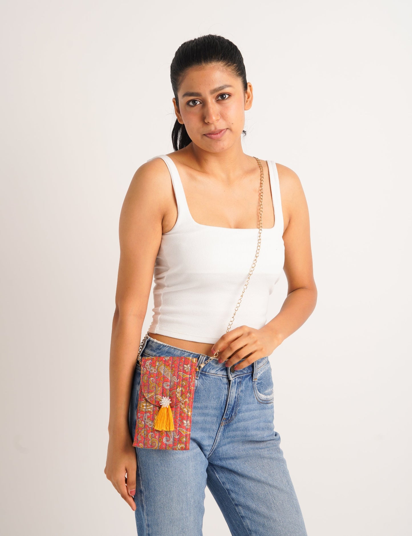 Stylish mobile phone pouch with tassel charm. Made from sustainable materials for eco-friendly fashion.