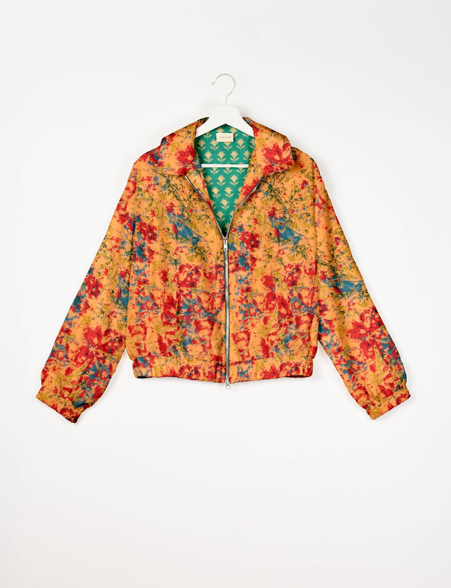 Stylish BOMBER JACKET, an upcycled clothing masterpiece with a cute cropped shape, elasticated details, and detachable metallic zipper. Contrast sari print lining adds a unique touch. Explore sustainable and eco-friendly fashion.